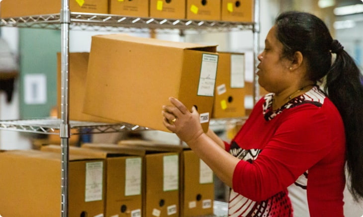 our records management coordinator placing a box on a shelf