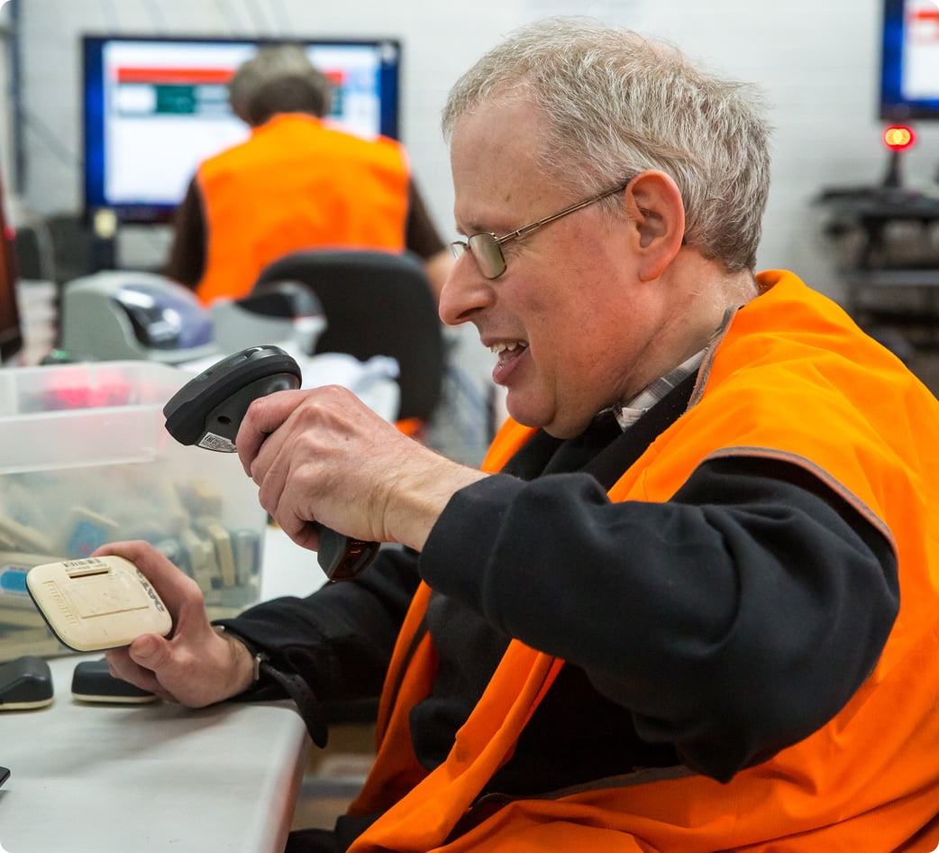 cheerful male employee scanning eTag's in our Transurban mail room.